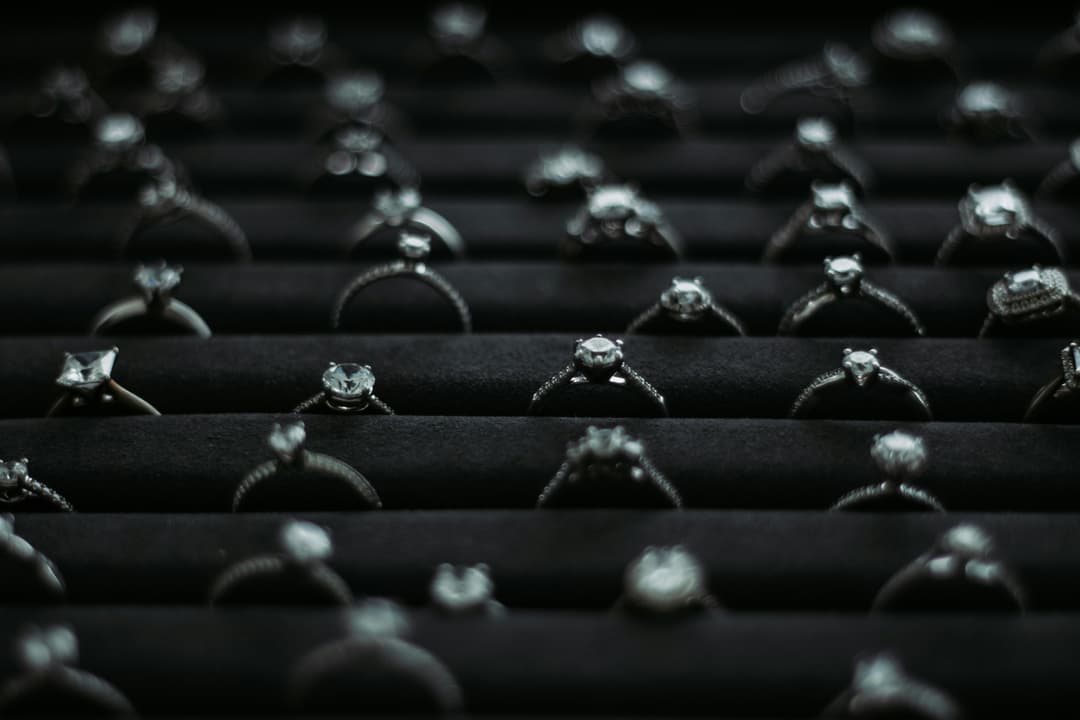 Sparkling diamond jewelry collection with various cuts and settings on black velvet